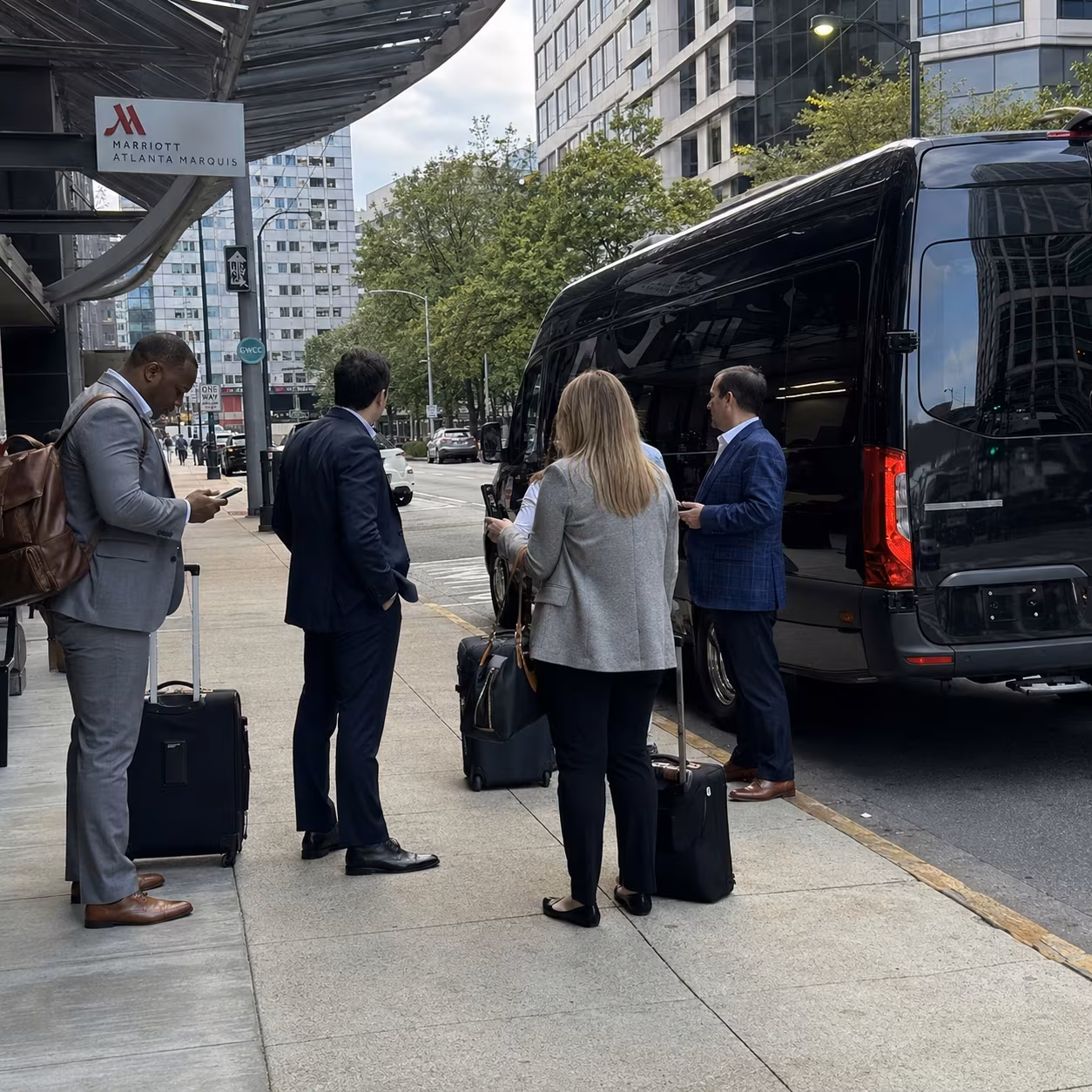 Passengers boarding a white charter bus as the driver assists with luggage