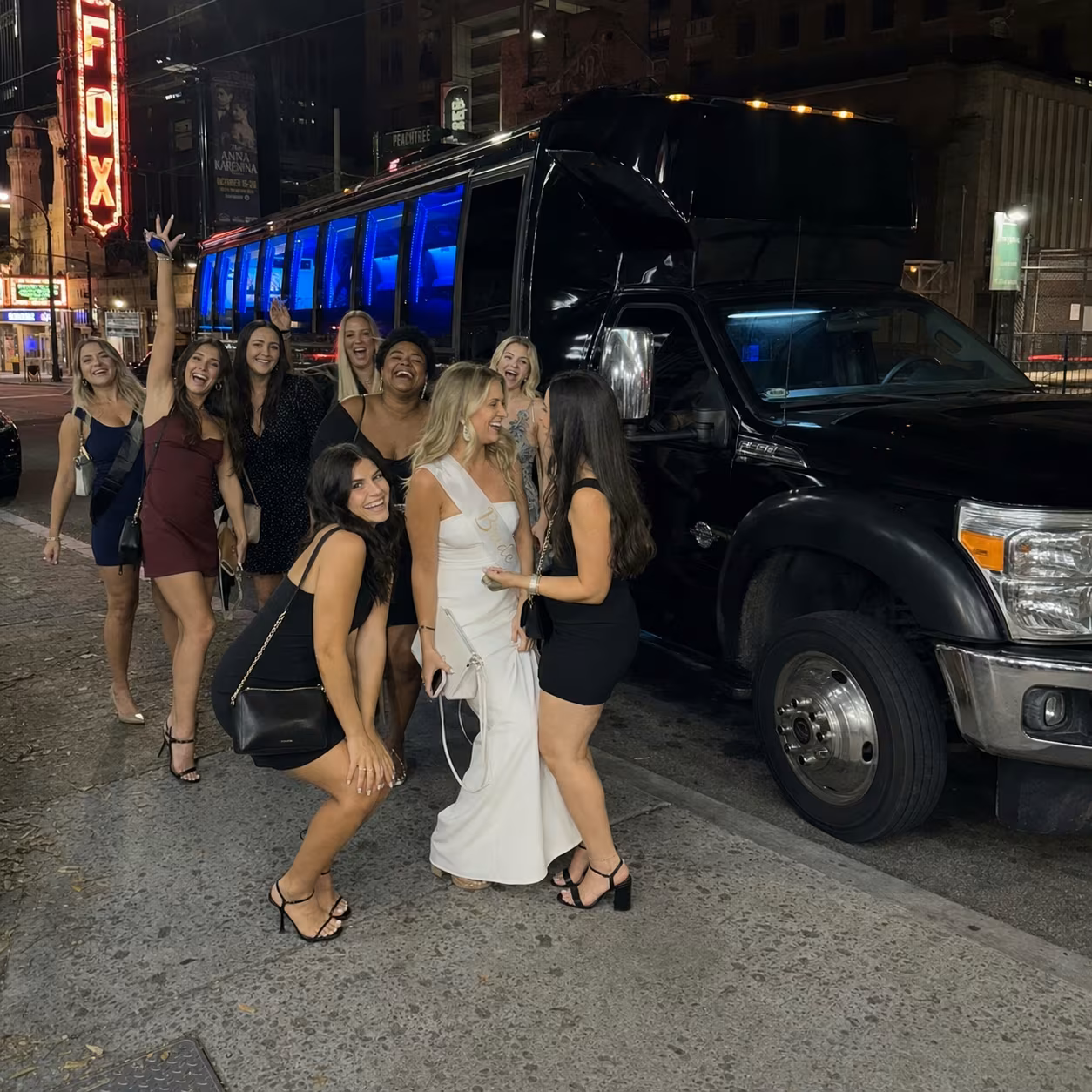 Downtown bachelorette curbside for a metro Atlanta bachelor & bachelorette party bus rental
