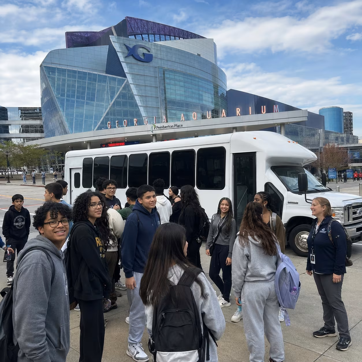 School event bus minibus group at venue for a metro Atlanta school & field-trip bus rental